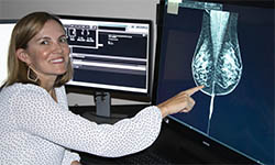 Dr. Rebecca Leddy points to a mammogram image on a computer screen